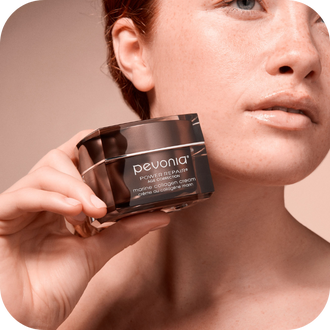 Image features a woman holding the Power Repair Marine Collagen Cream