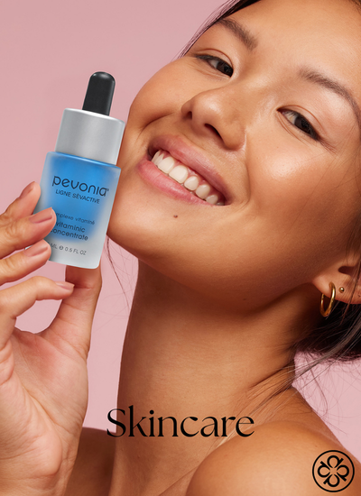 Skincare products - image features a woman holding Pevonia Vitaminic Concentrate