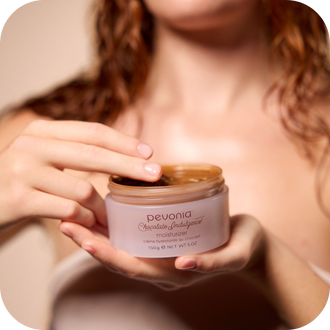 Image features a woman holding the Chocolate Indulgence Moisturizer